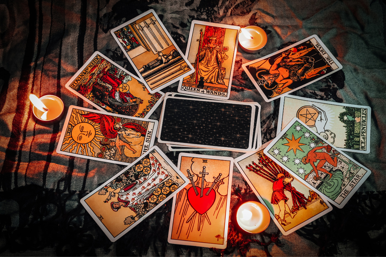 Tarot reading with tarot card background and candlelight on.