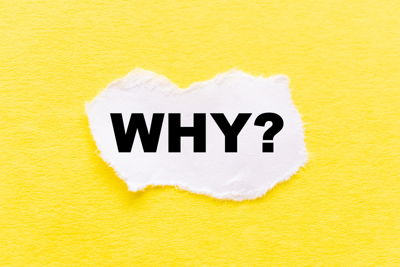 The text Why appearing behind torn yellow paper.