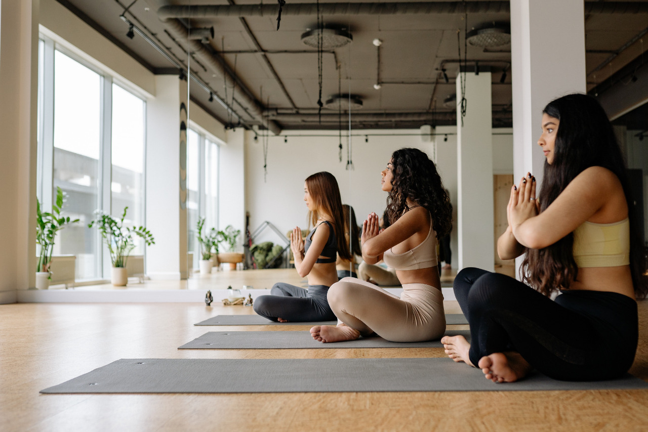 Three Women Meditating in a Yoga Class in sideview.