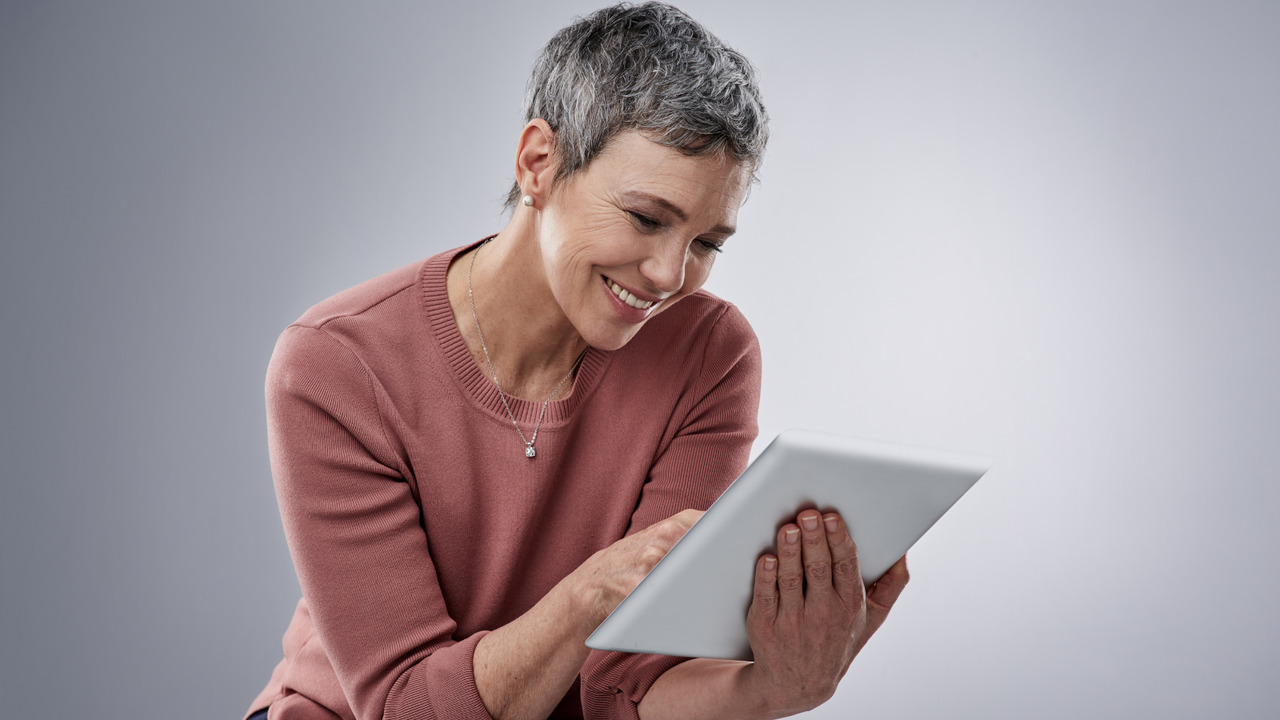Woman smiles while browsing website that is user-friendly.