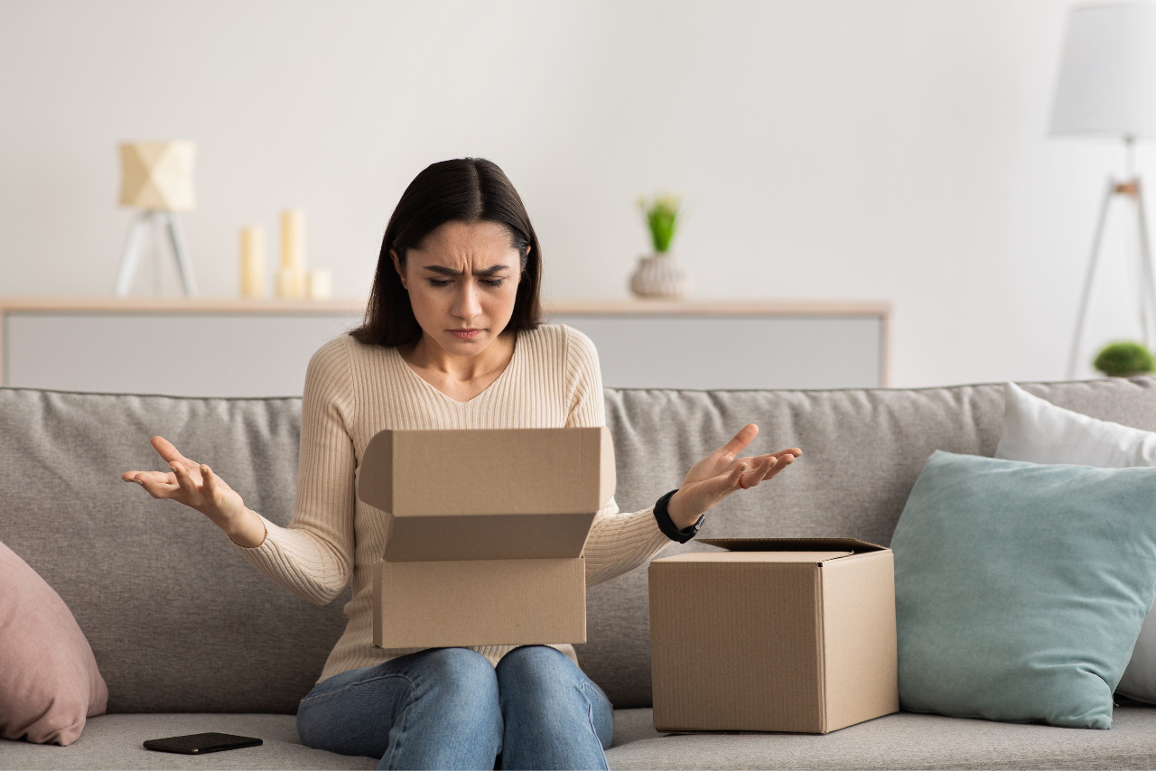 Woman with negative emotions due to damaged items received from package.