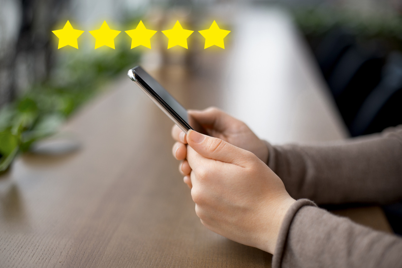 Woman's hand typing her reivew for online store using phone.
