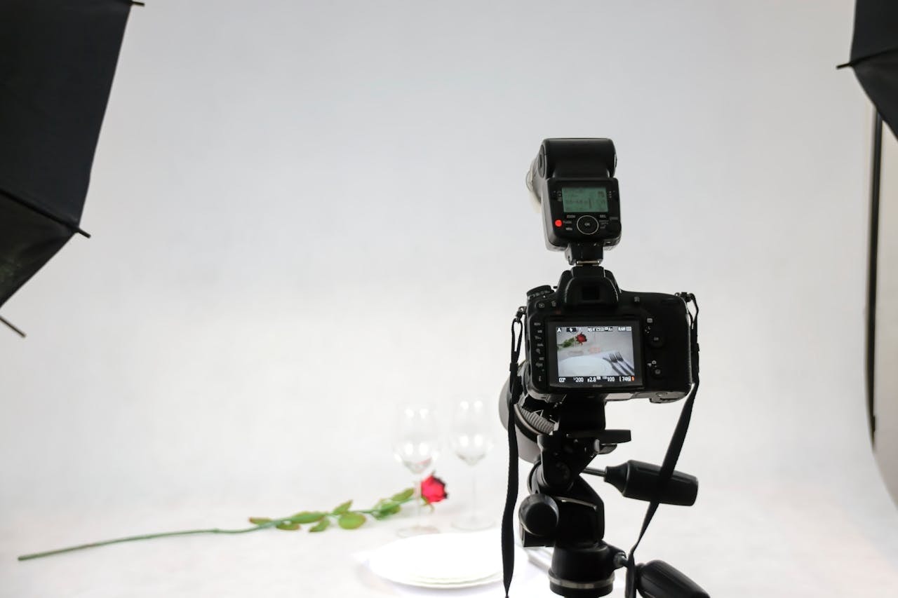 A DSLR camera attached to a tripod in a studio