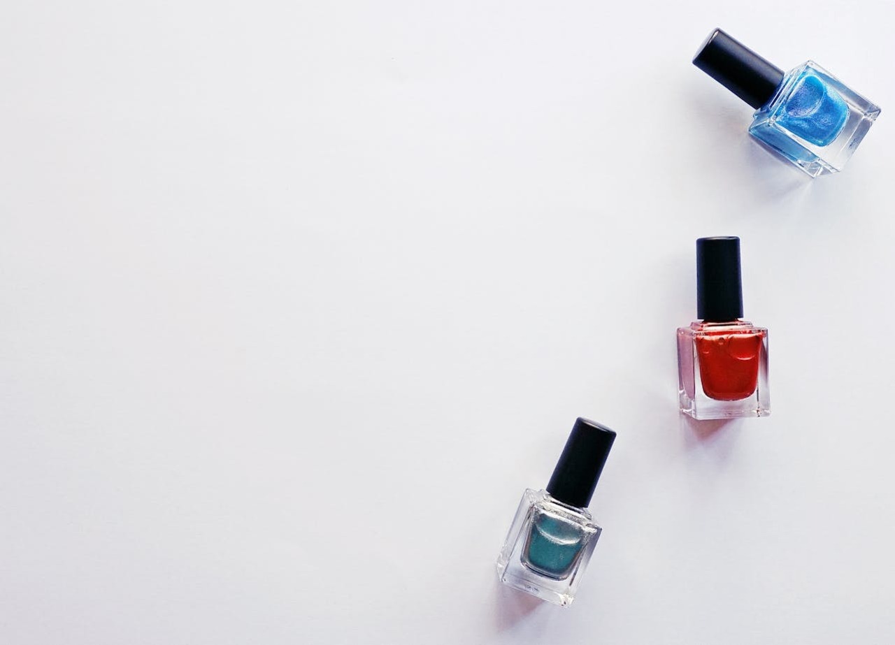 Different shades of nail polish on a white background