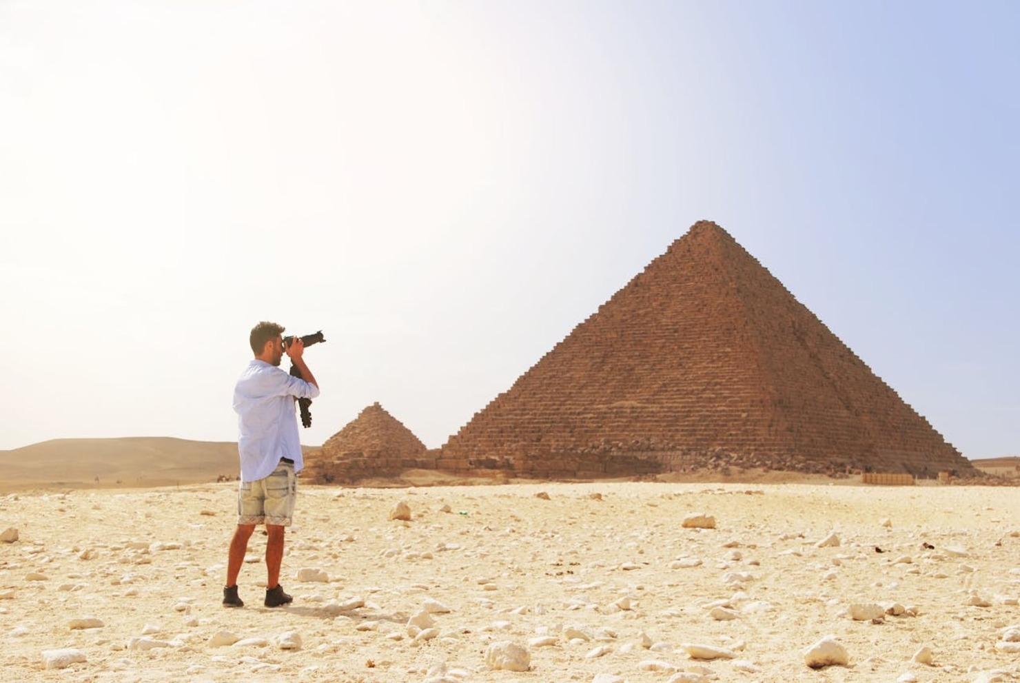 A man taking a photo of the great pyramid