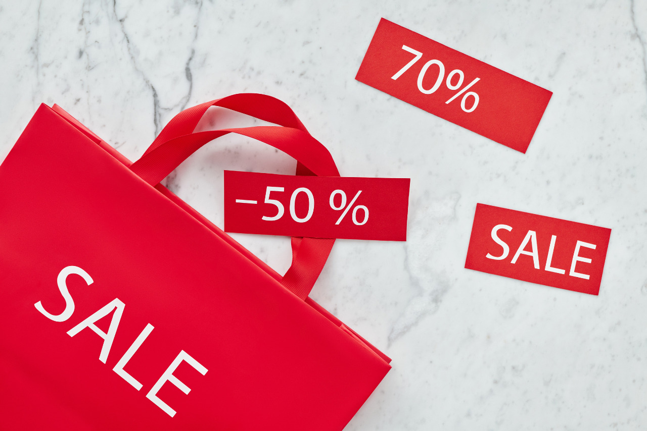 Close-up Photo of Red Paper Bag with various discount percentage.