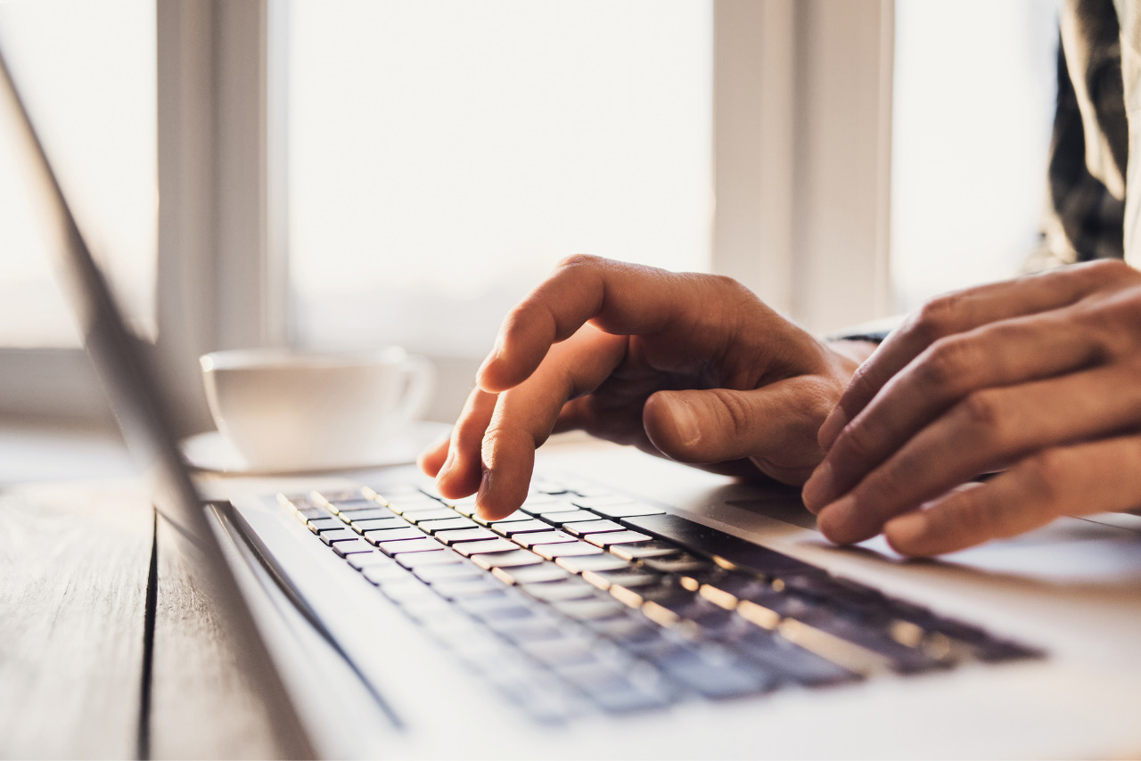 Businessman using laptop computer and setting up online store.
