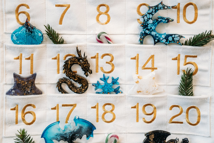 Hand sewn fabric advent calendar with different ornaments.
