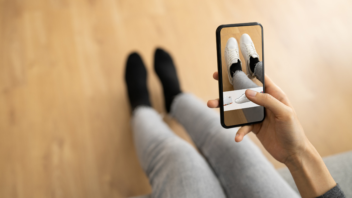 Woman trying virtual sneakers in online shop.