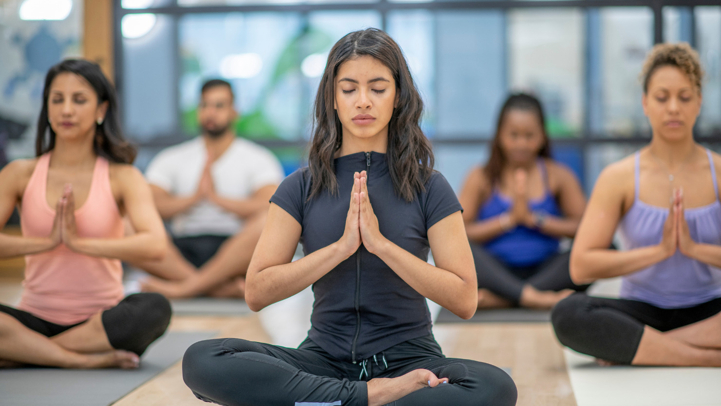 Diverse group of people in fitness and yoga class.