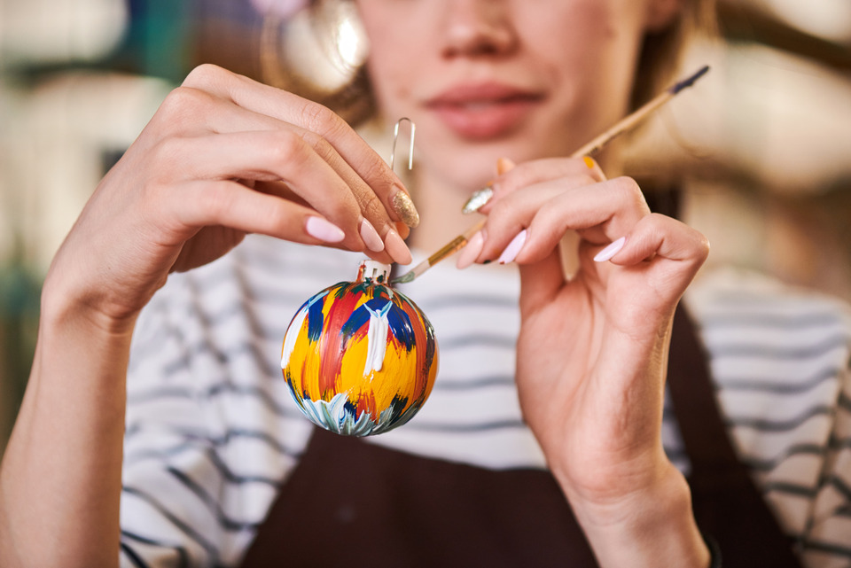 Woman Painting Christmas Ornament Closeup.