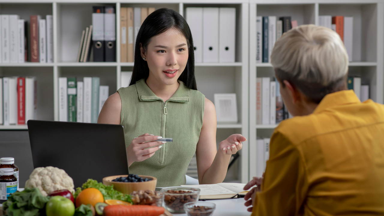 Asian nutritionist teaming up with fitness company owner.