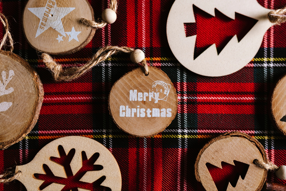 Wooden Ornaments with Christmas Message on a Red Tartan.