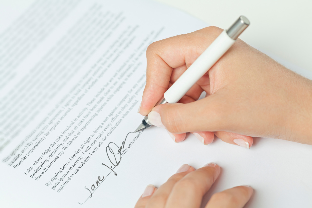 Hand singning the purchase agreement.