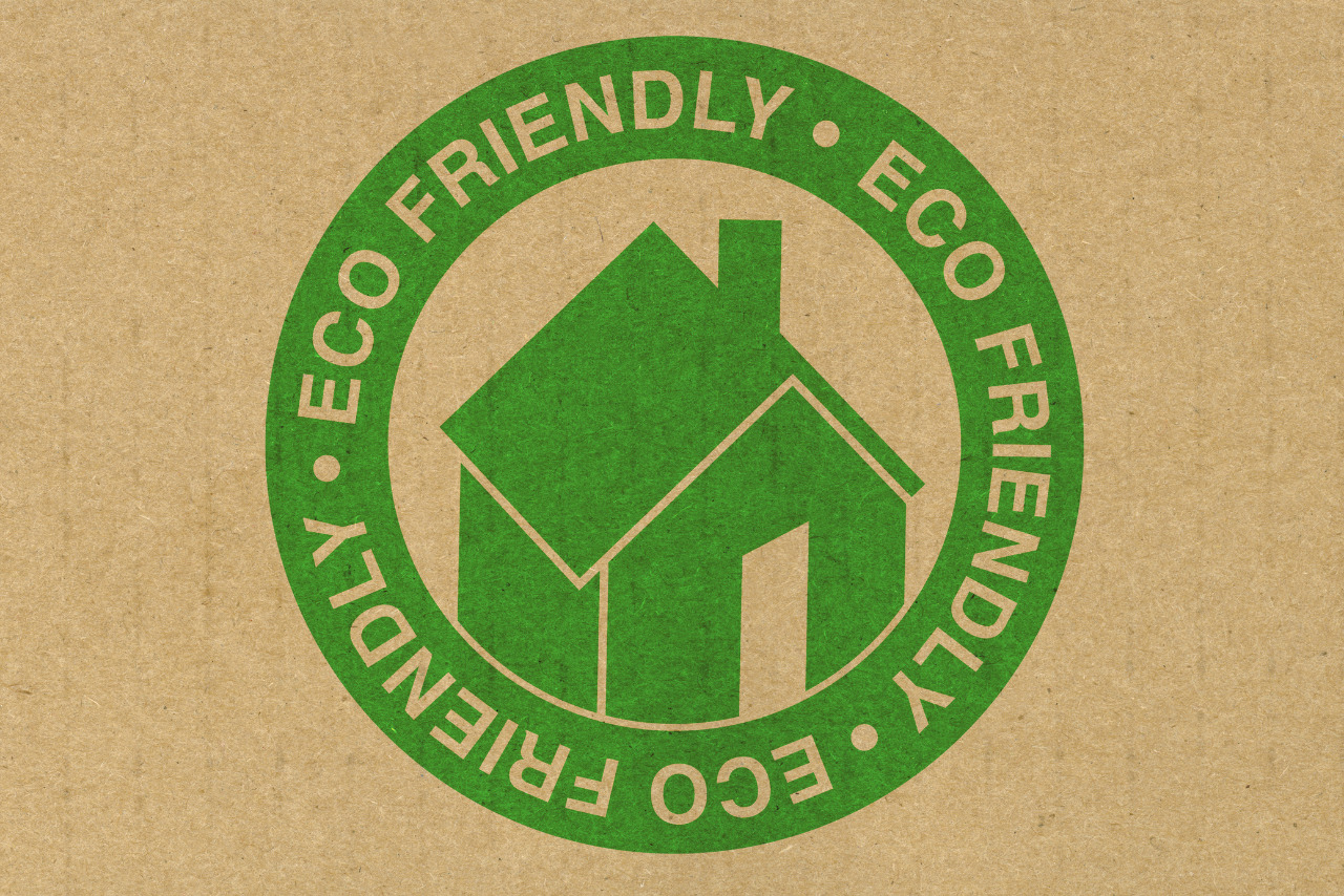 Eco-friendly house icon on cardboard surface.
