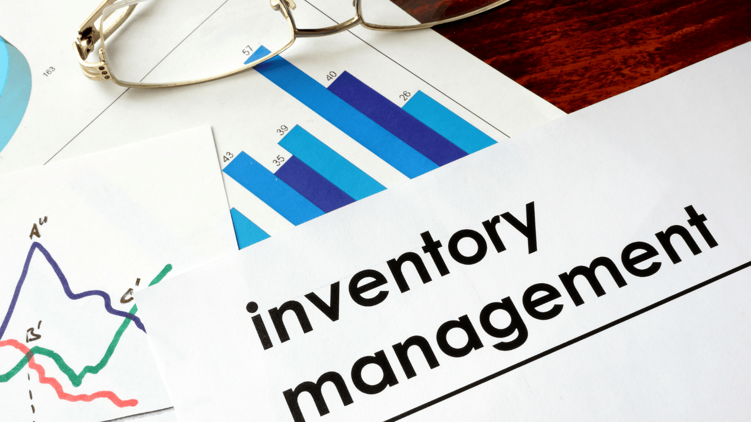 Paper with words inventory management and charts.