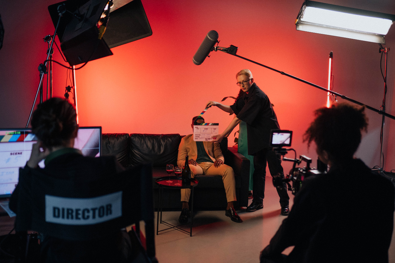 Director, cameraman, clapperman and actor on set.
