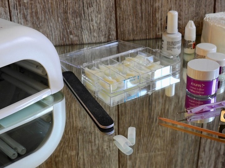Nail polish, nail gel and artificial fingernails on a surface.