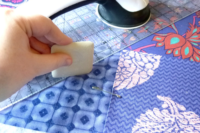 Marking linings by hand to prepare for sewing a T-shirt quilt.