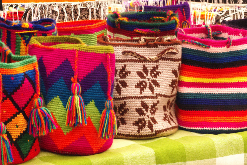 Colorful knitting bags on table.