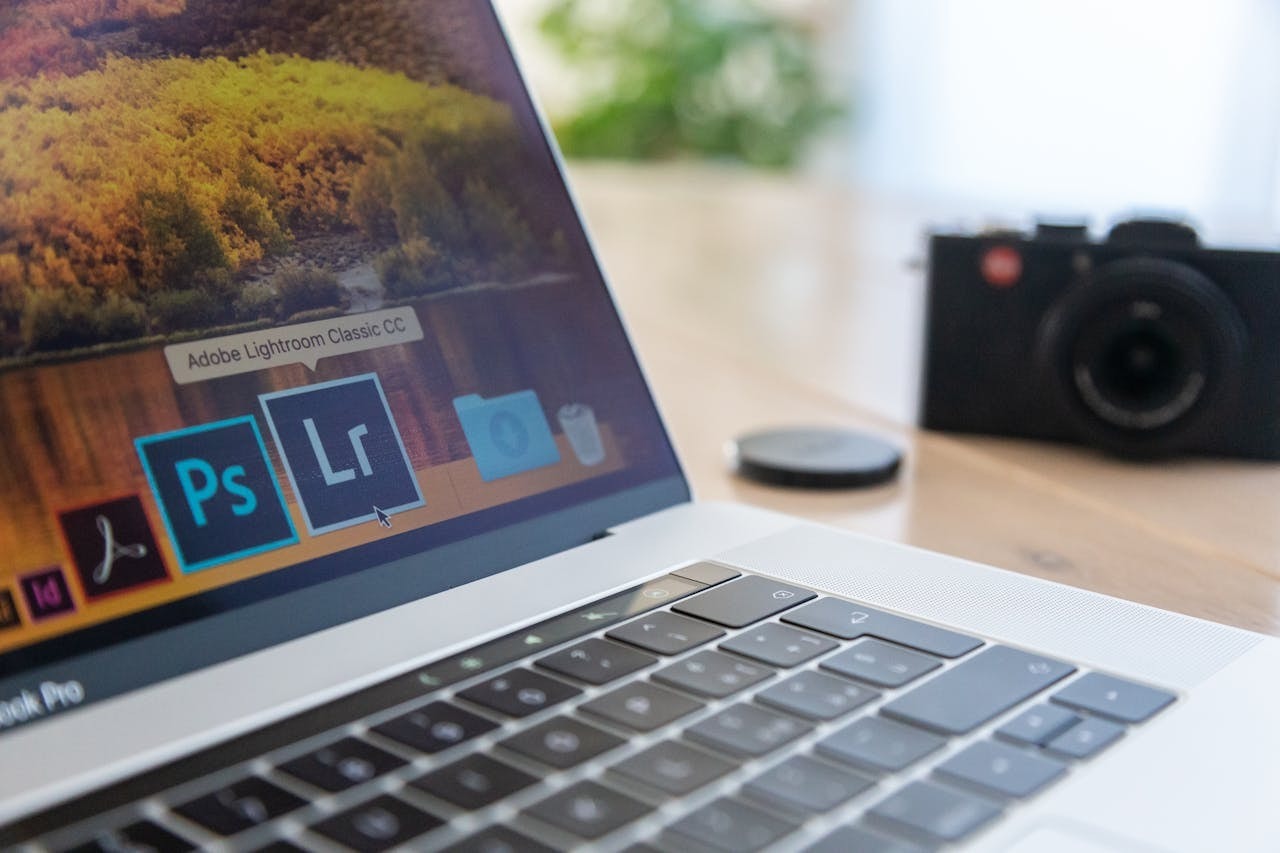 Selective focus shot of a laptop showing the Adobe Lightroom icon