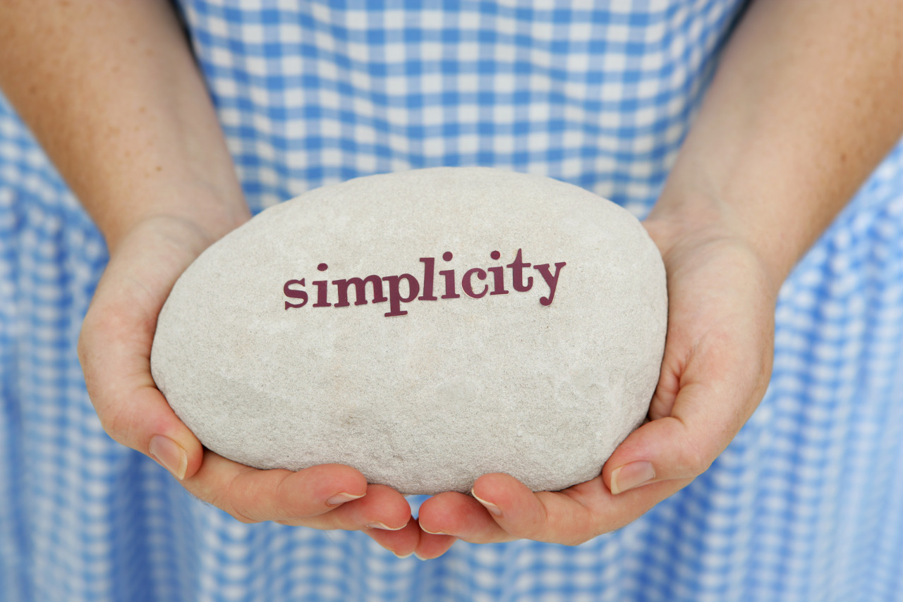 Simplicity written on stone and carried by young person.