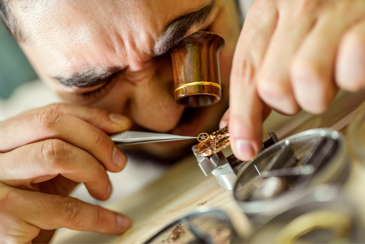 Closeup of watchmaker repairing broken watch.