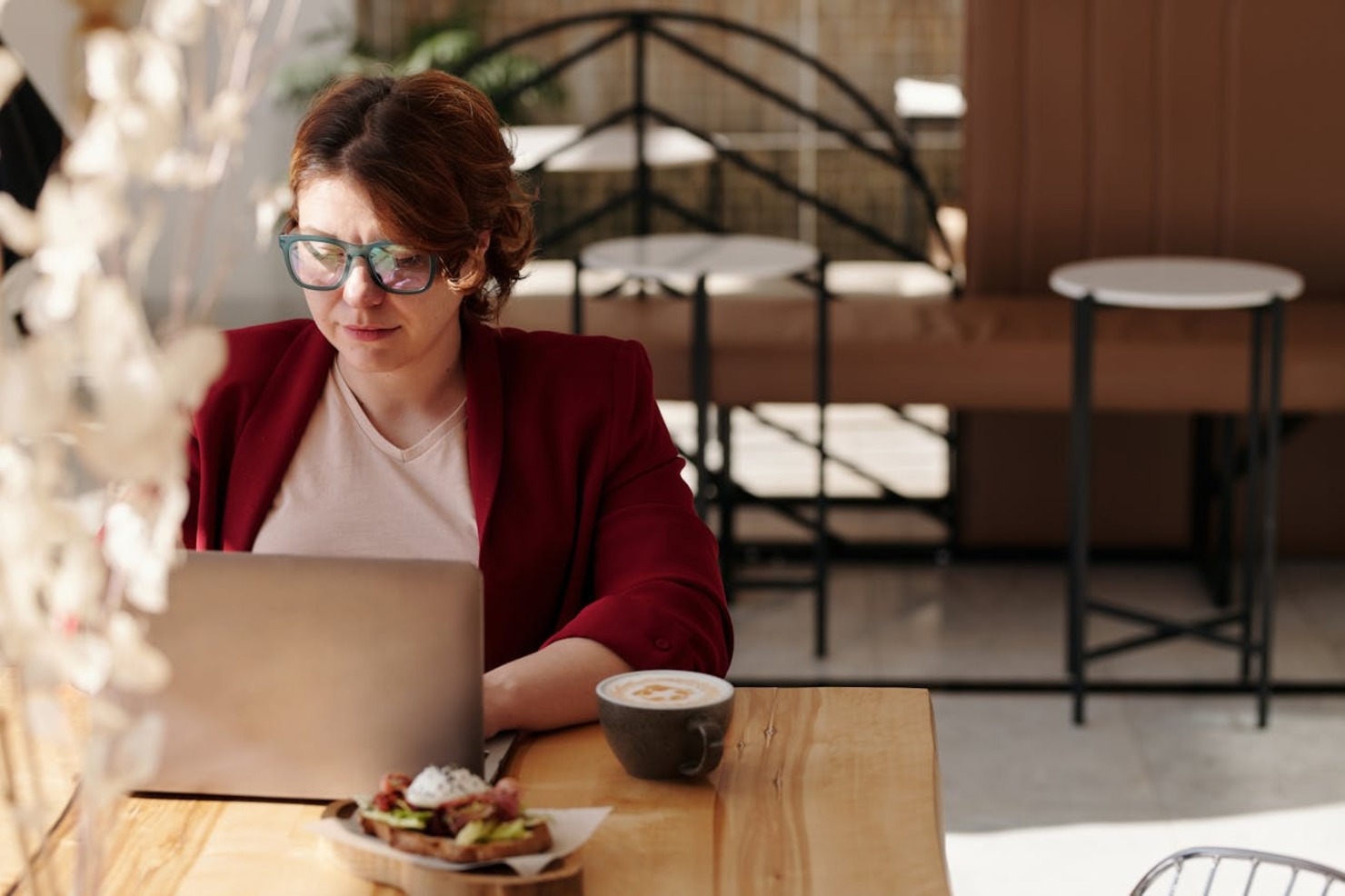 A woman working remotely at a cafe