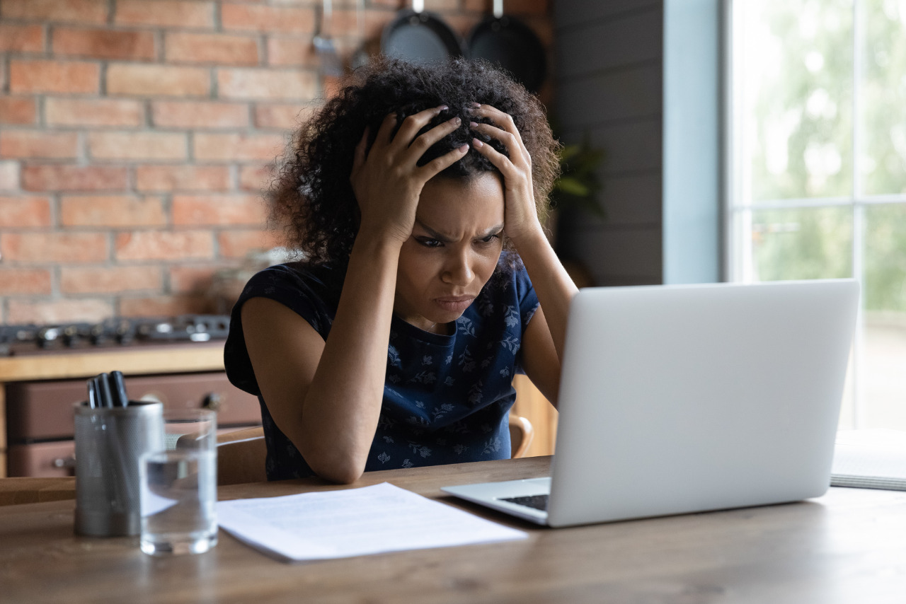 Confused young woman looking confused at navigating a website from her computer.