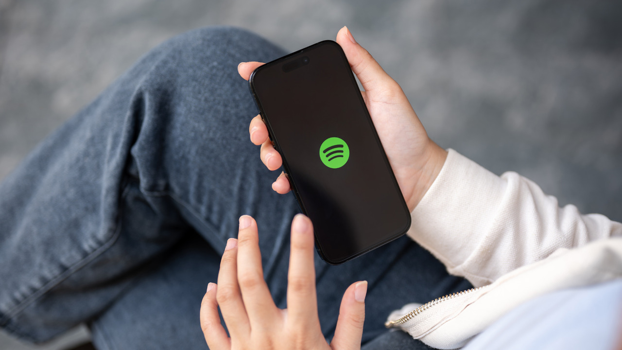 Young person using the spotify app on phone.