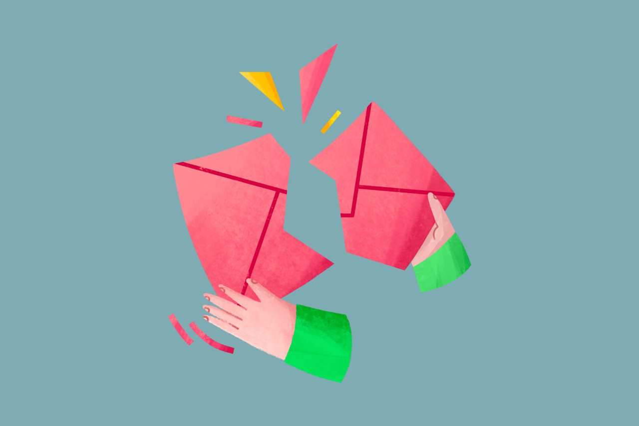 Hands tearing up mail envelope signifying unsubscribing.