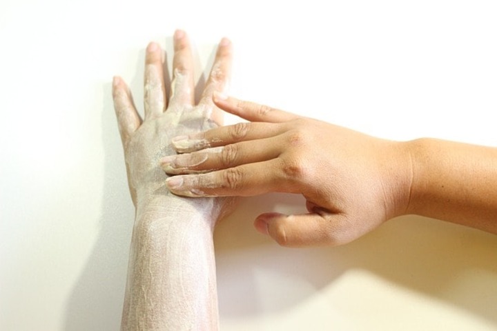 A person doing a hand scrub.