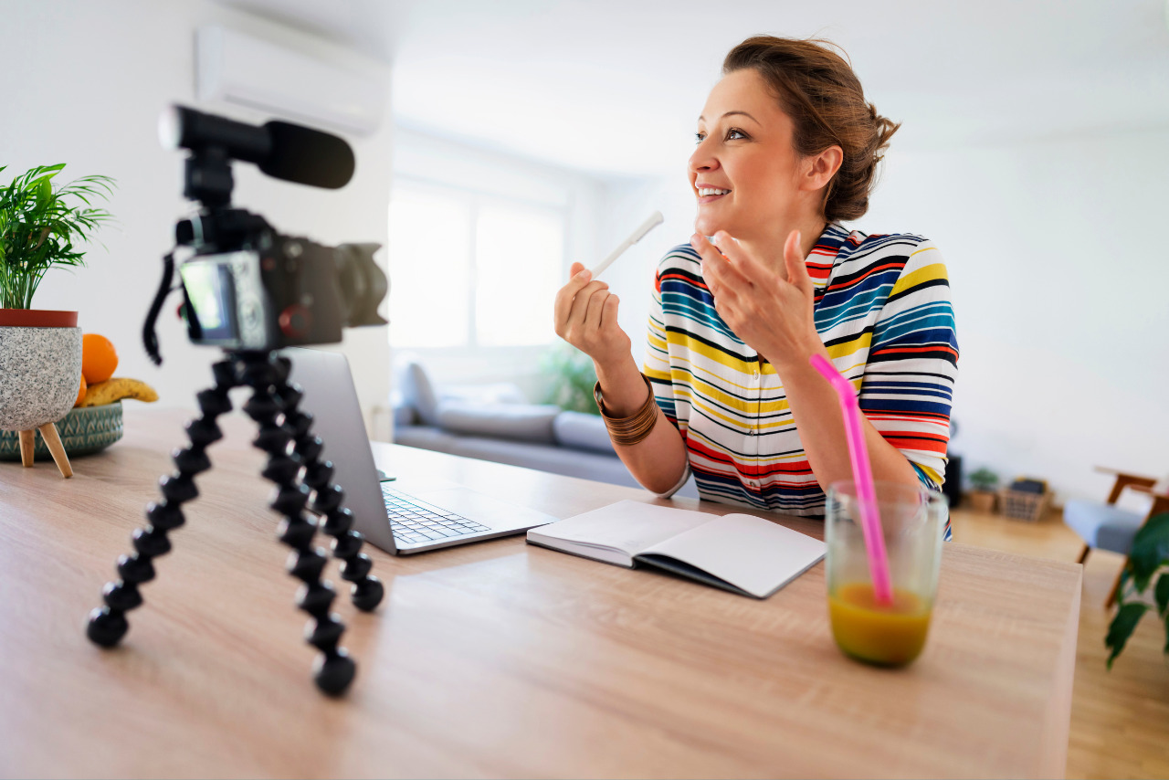 A woman nonprofit owner records herself sharing her life story.