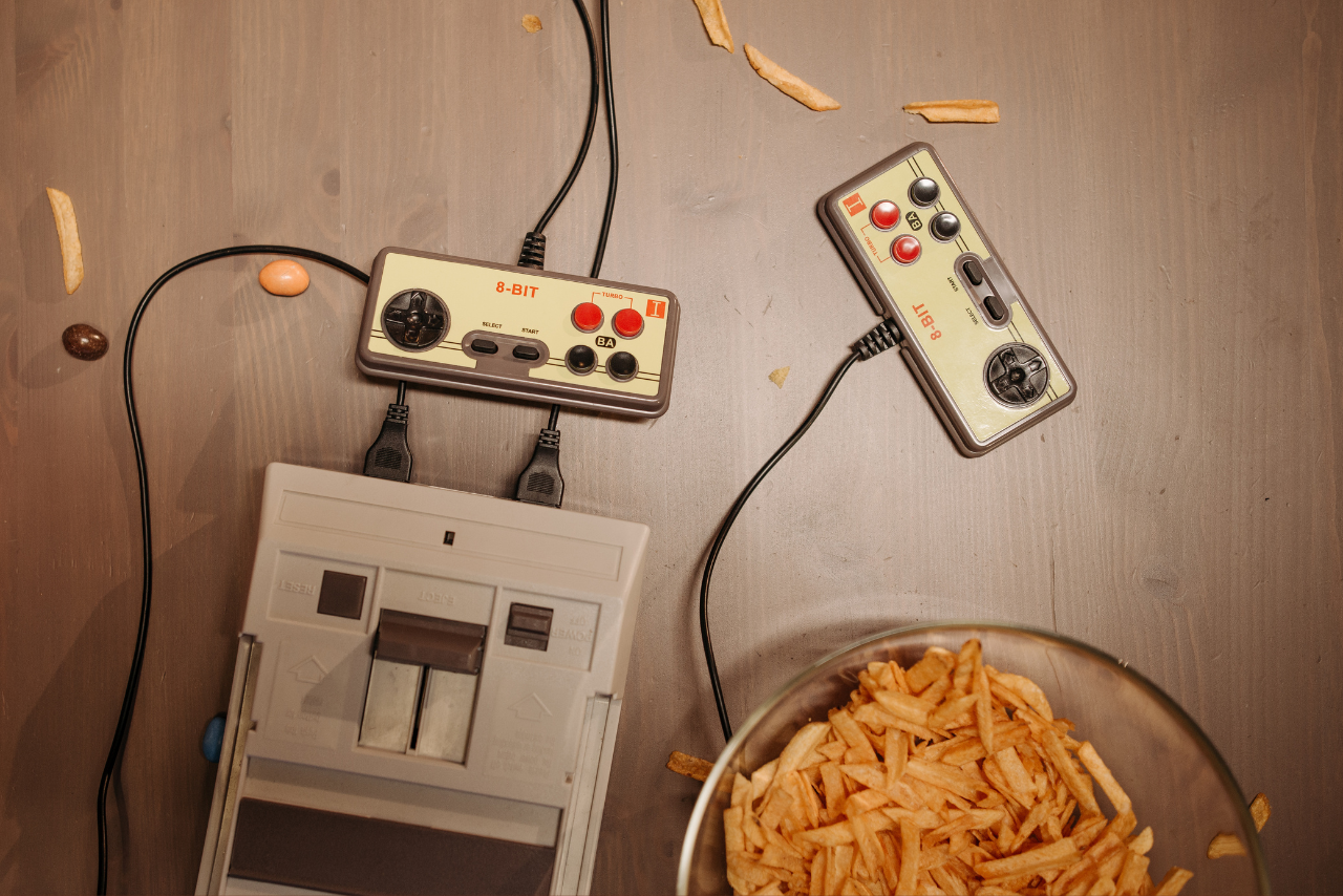 A Vintage Video Game Console on a Wooden Surface.