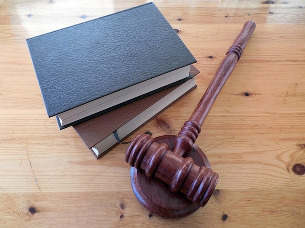 A court hammer and books with regulations.