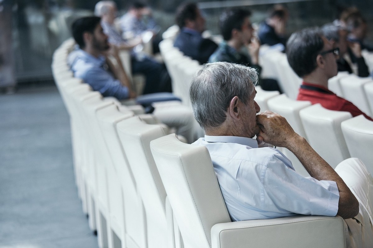 An attentive audience of middle-aged people.