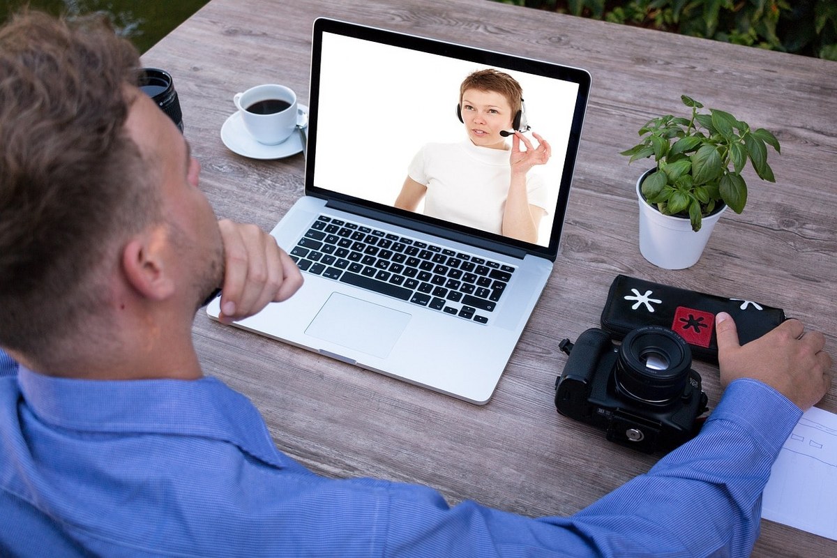 An online tutor giving lessons on a webinar meeting.