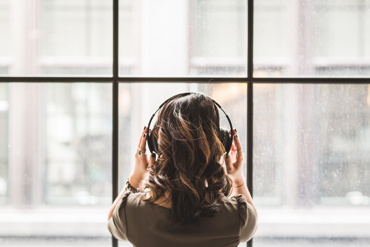 Behind shot of woman wearing headphones.