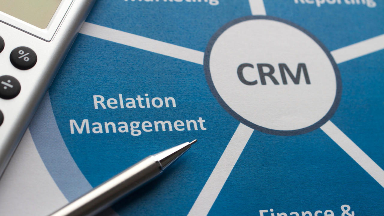 CRM infographics displayed on a sheet of paper.