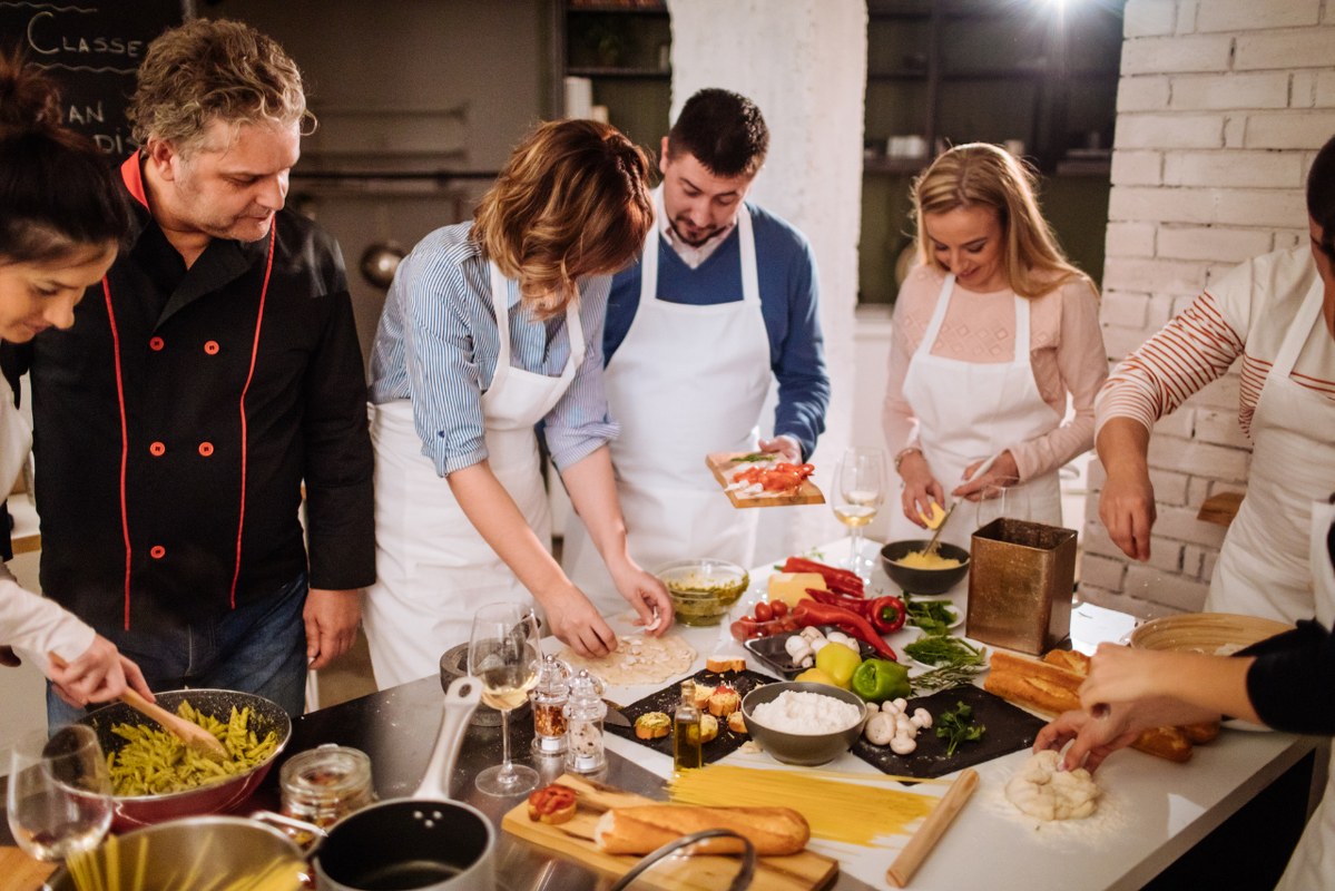 Chef with students while in cooking class.