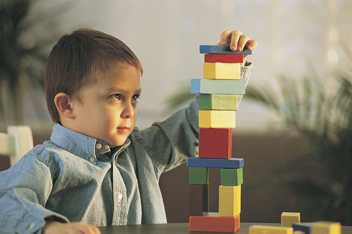 Child plays with wooden blocks.