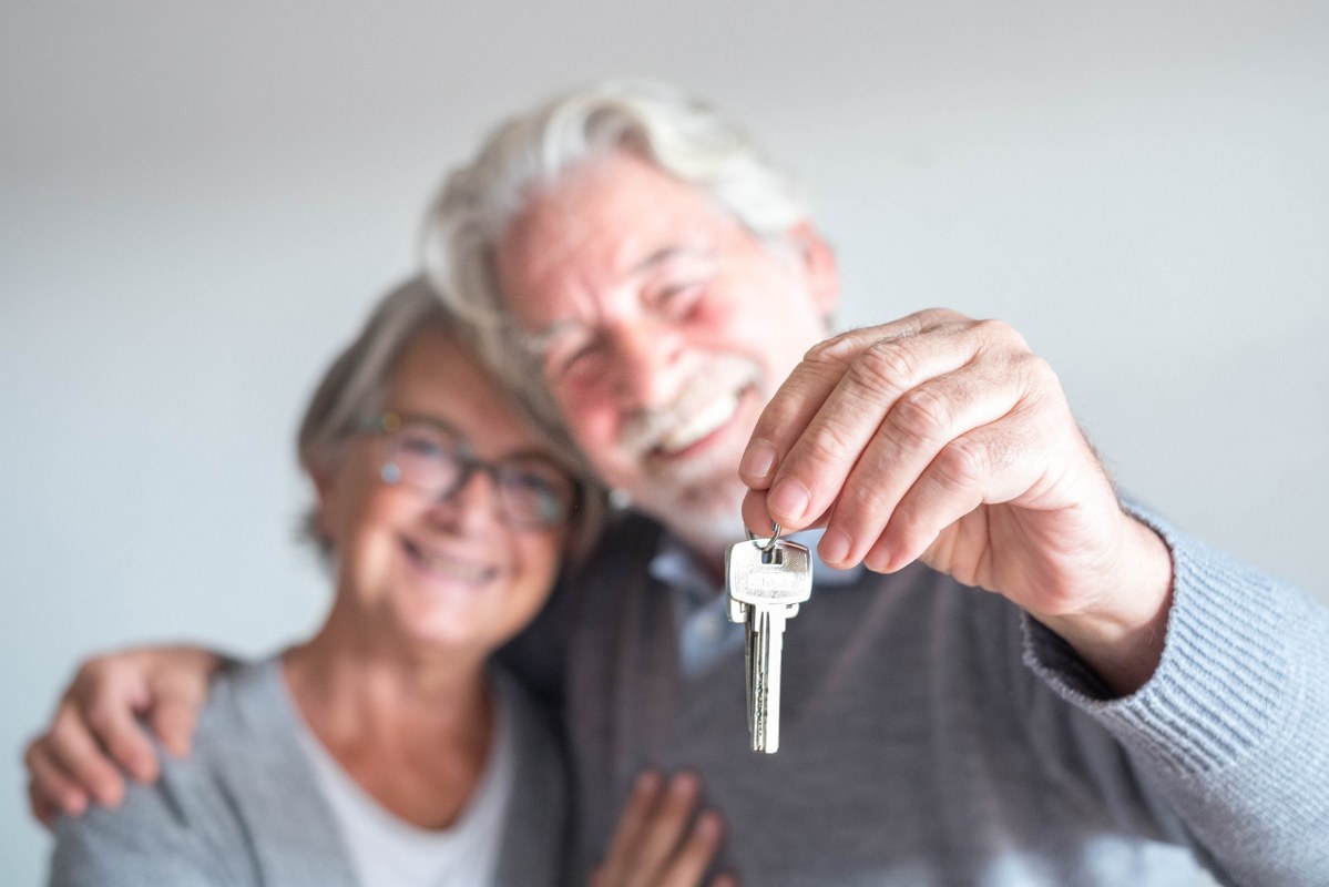 Couple of Seniors Holding House Keys.