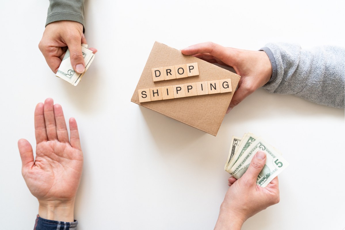 Dropshipping concept - hands exchanging money and product.
