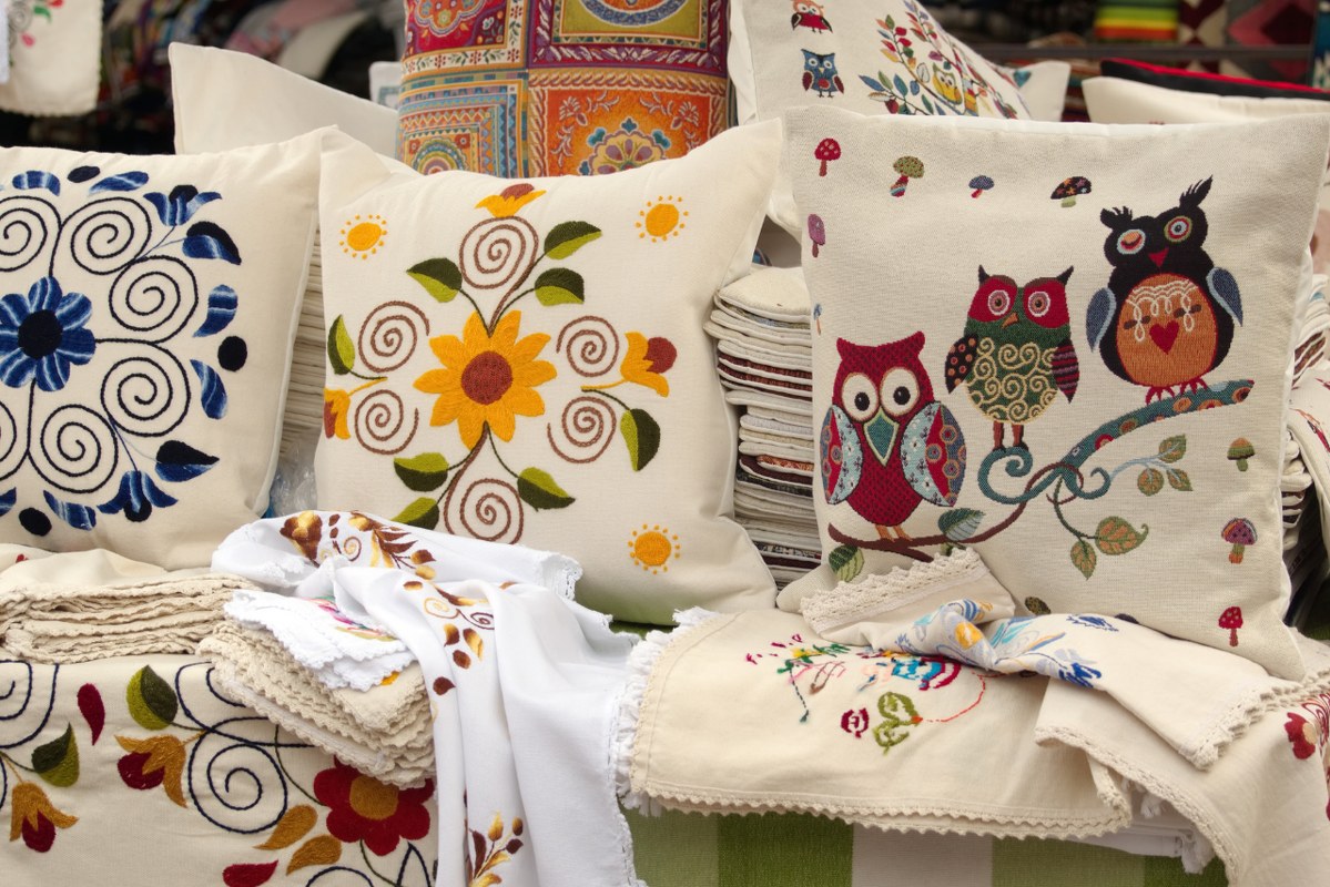 Embroidered pillows displayed at market.