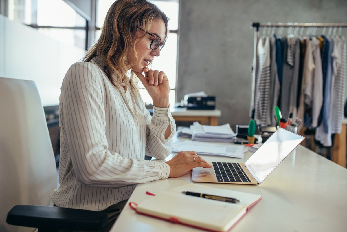 Female dropshipping Business Owner Looking for New Orders on laptop.