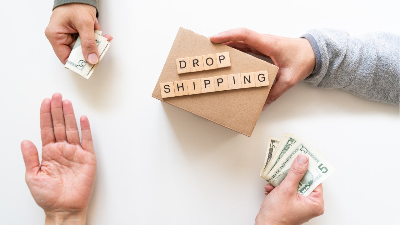 Four hands: two holding money, one holding a parcel labeled 