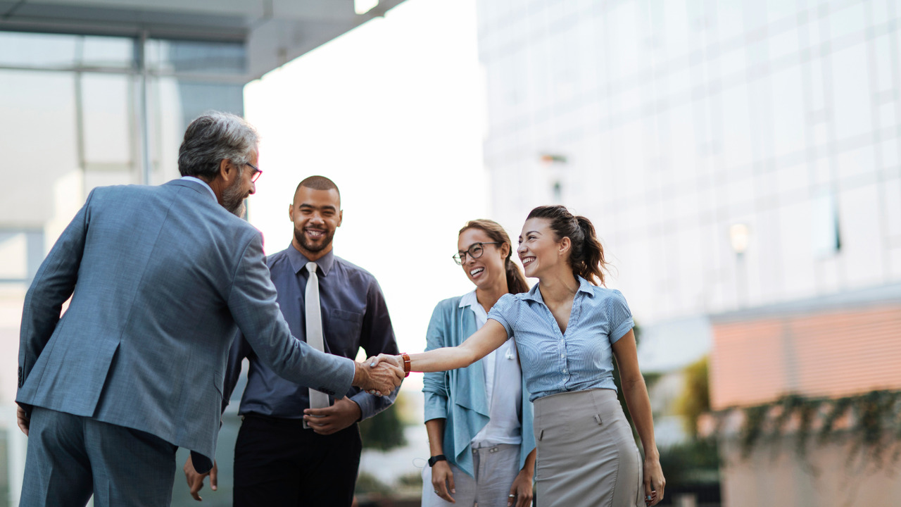 Group of business people partner together.