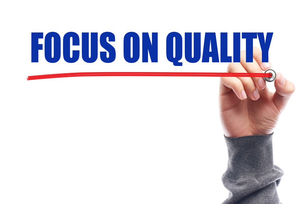 Hand drawing red line under Focus on Quality Slogan.