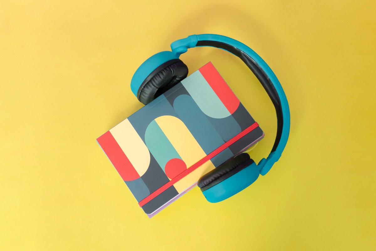 Headphones Around a Book signifying auditory learning.