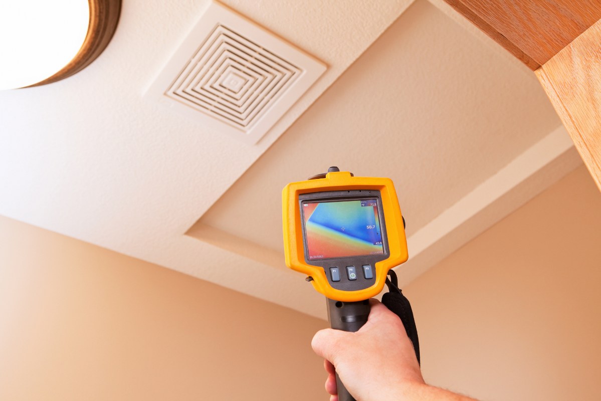 Infrared Thermal Imaging Camera Pointing to Attic Access.